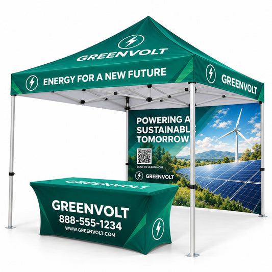A Greenvolt branded pop-up canopy tent with a matching branded table, shown on a clean white studio background. The canopy is dark green with white text and lightning bolt logos, and the table has a similar green top with white branding and a phone number.