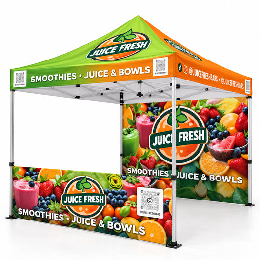 A pop-up canopy tent with custom juice bar branding, featuring a green and orange roof and printed fruit-and-smoothie graphics on the side walls. The canopy is shown on a plain white background.