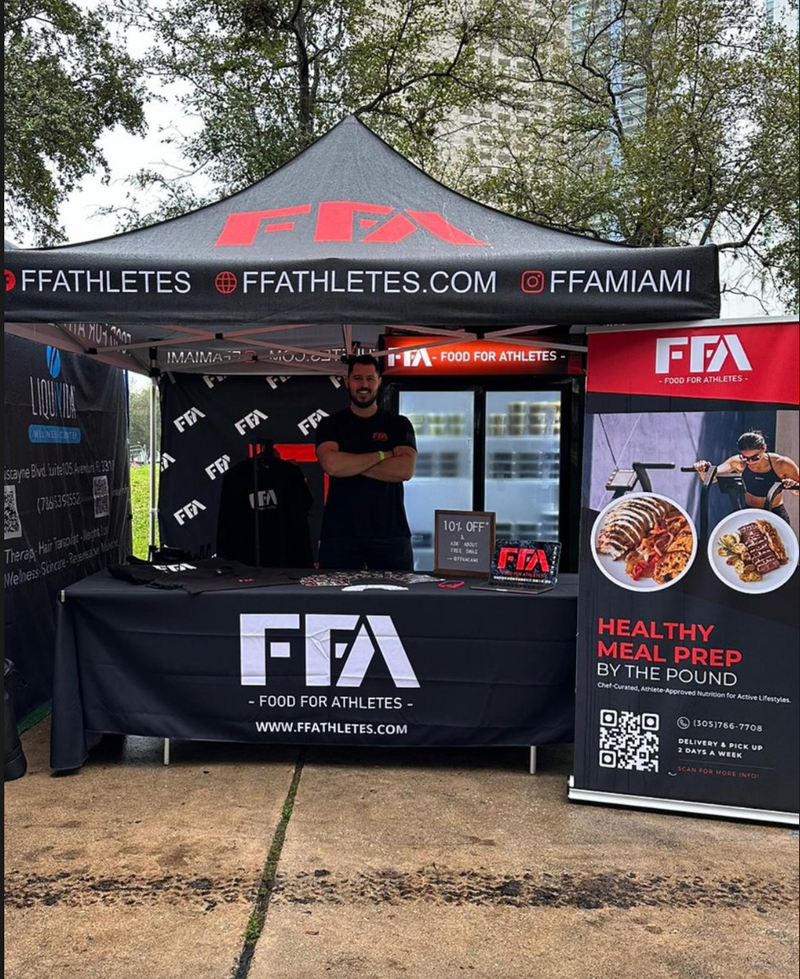 FFA (Food for Athletes) booth with branded tent and banner at an outdoor event.